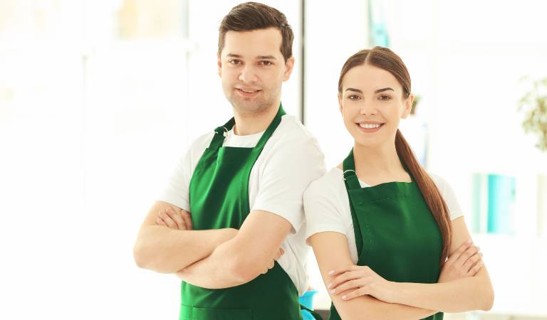 Man and a woman in white-green dress standing together and smiling