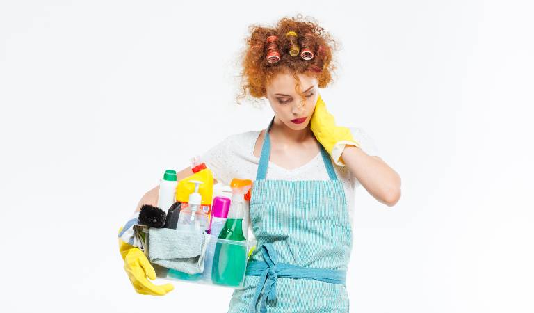 Woman in uniform holding a basket filled with tools and products