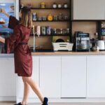 Woman in brown dress organising her kitchen