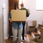 Boxes moving and couple in home together
