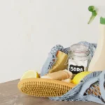 Eco cleaning kit in mesh bag on the table spray bottle soda lemon and natural cleaning sponges